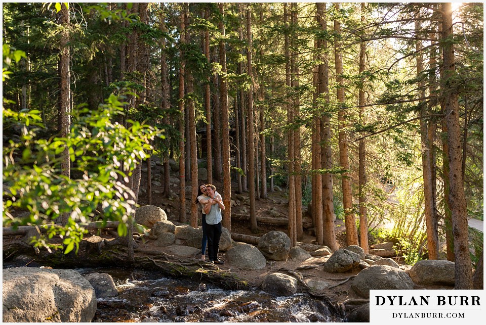colorado mountain engagement photos colorado wedding photographer dylan burr couple holding each other by the river