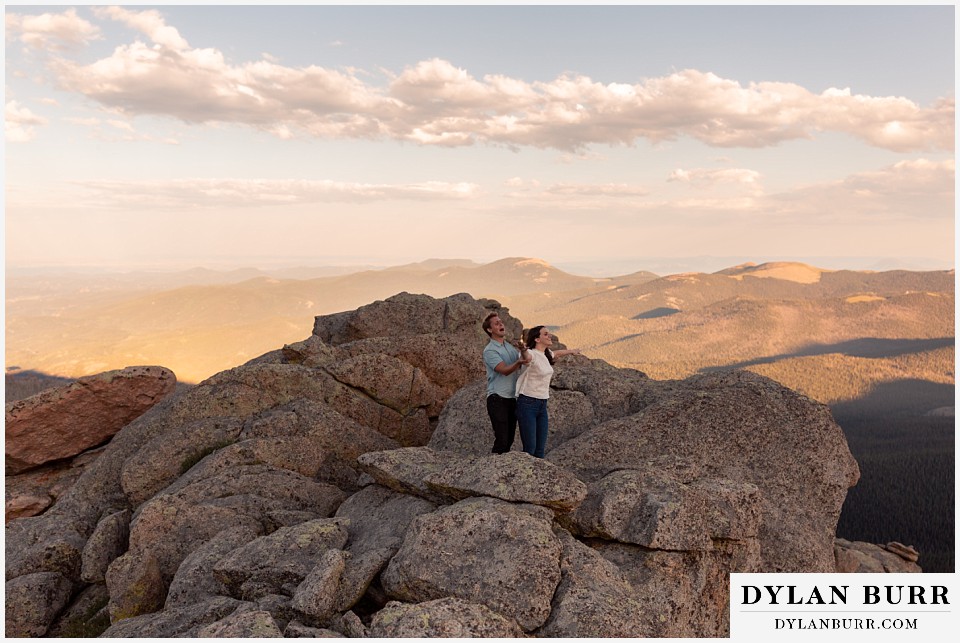 colorado mountain engagement photos colorado wedding photographer dylan burr couple flying in wind on top of rocks