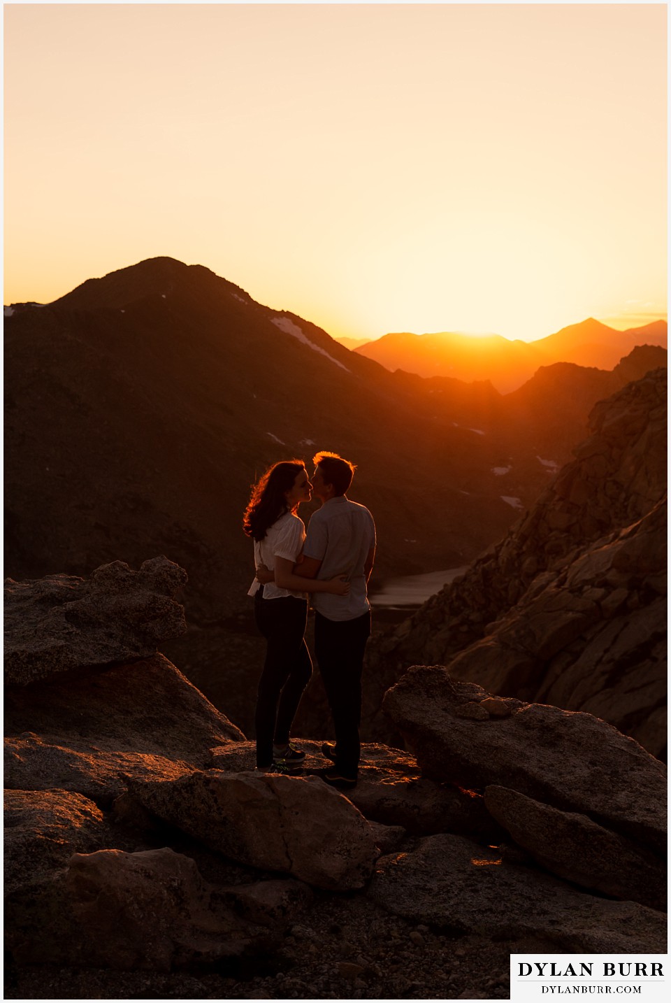 colorado mountain engagement photos colorado wedding photographer dylan burr couple at sunset on top of mountains leaning over for a kiss
