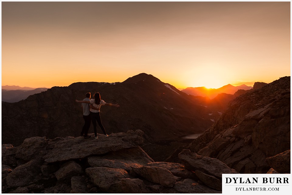 colorado mountain engagement photos colorado wedding photographer dylan burr couple putting out arms flying in the wind at sunset