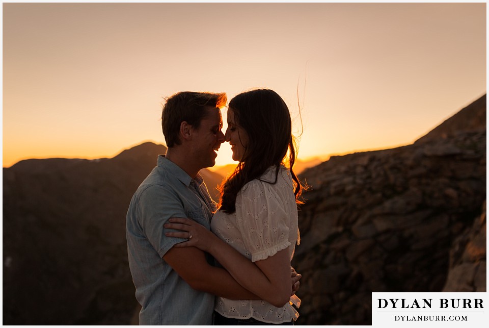 colorado mountain engagement photos colorado wedding photographer dylan burr couple at sunset in mountains laughing together