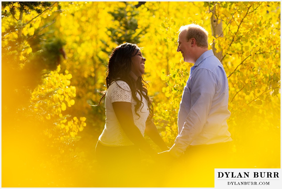 colorado mountain engagement photos couple together in yellow aspen trees