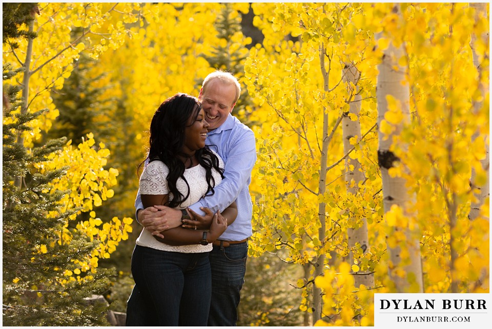 colorado mountain engagement photos couple hugging eachother and laughing