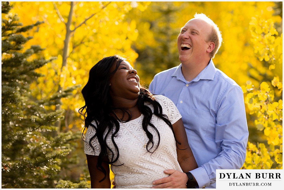 colorado mountain engagement photos african american bride and groom in mountains laughing