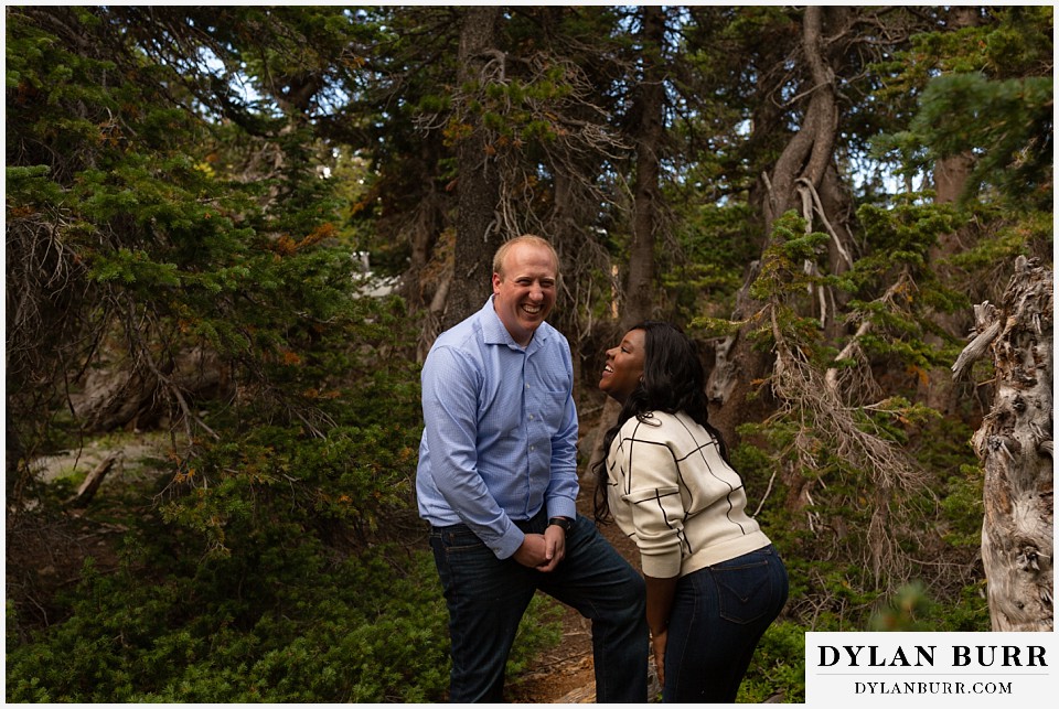 colorado mountain engagement photos couple laughing hard with eachother