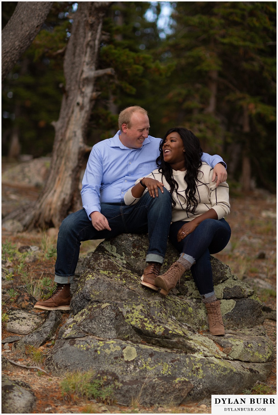 colorado mountain engagement photos couple talking together on rock in pine forest