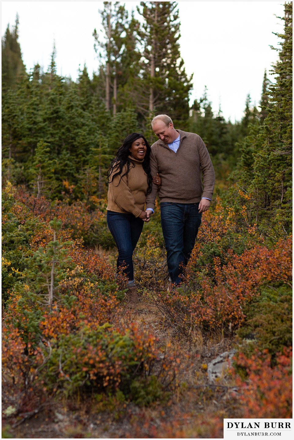 colorado mountain engagement photos couple holding his arm in mountain meadow