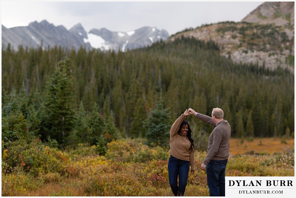 colorado mountain engagement photos dancing in a fall mountain meadow