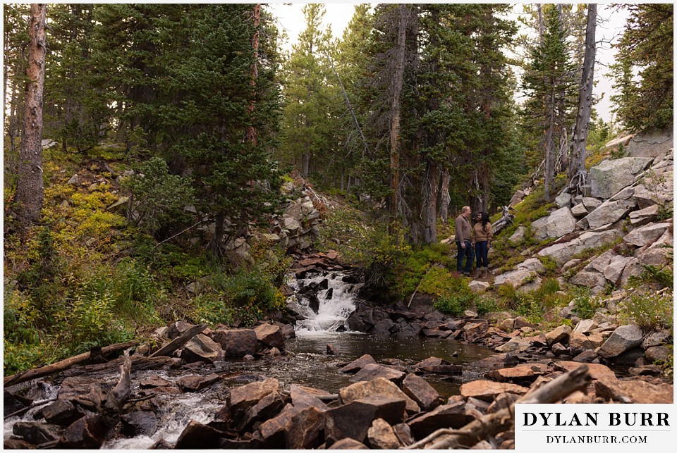 colorado mountain engagement photos couple at riverside with rockslide