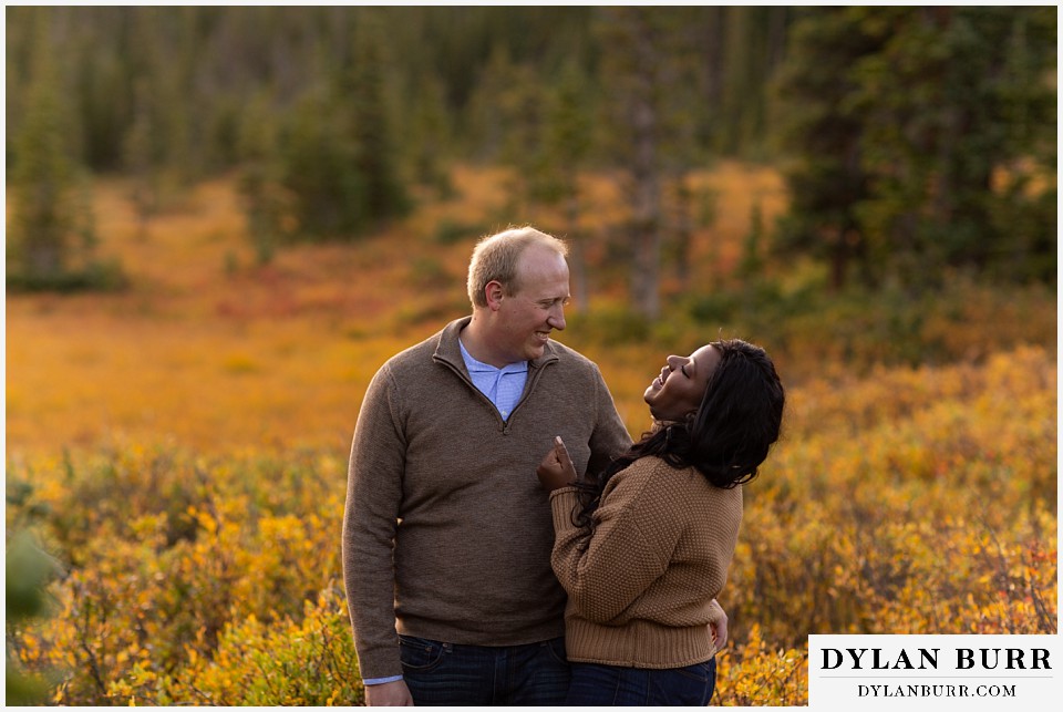 colorado mountain engagement photos couple together in meadow with gold leaves