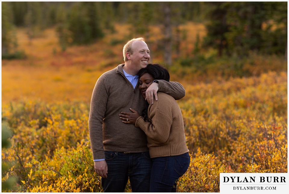 colorado mountain engagement photos groom hugging bride to be