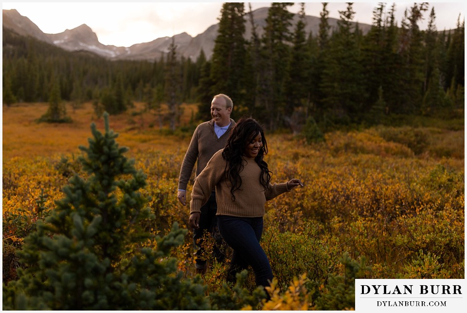 colorado mountain engagement photos couple walking through marsh