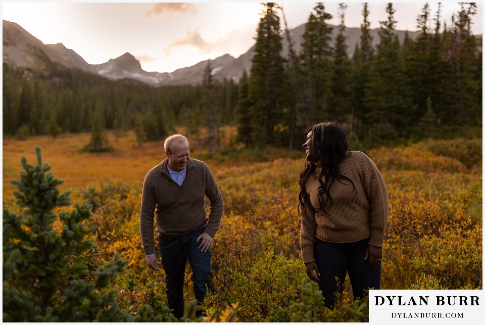 colorado mountain engagement photos couple laughing getting stuck in mud