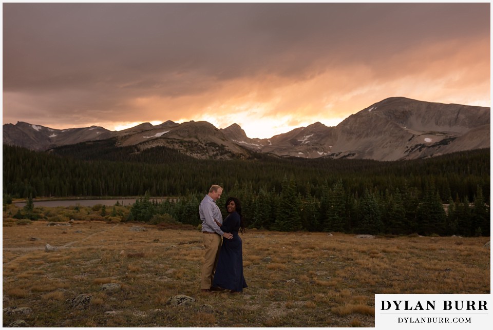 colorado mountain engagement photos couple together in mountains at sunset