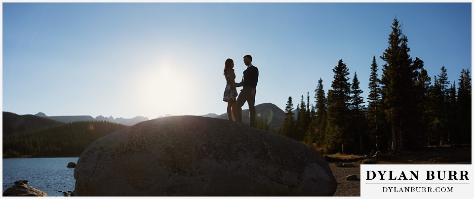 colorado engagement photos in mountains standing together on large rock