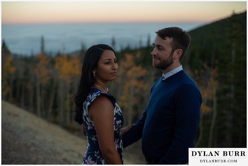 colorado engagement photos in mountains couple watching sunset