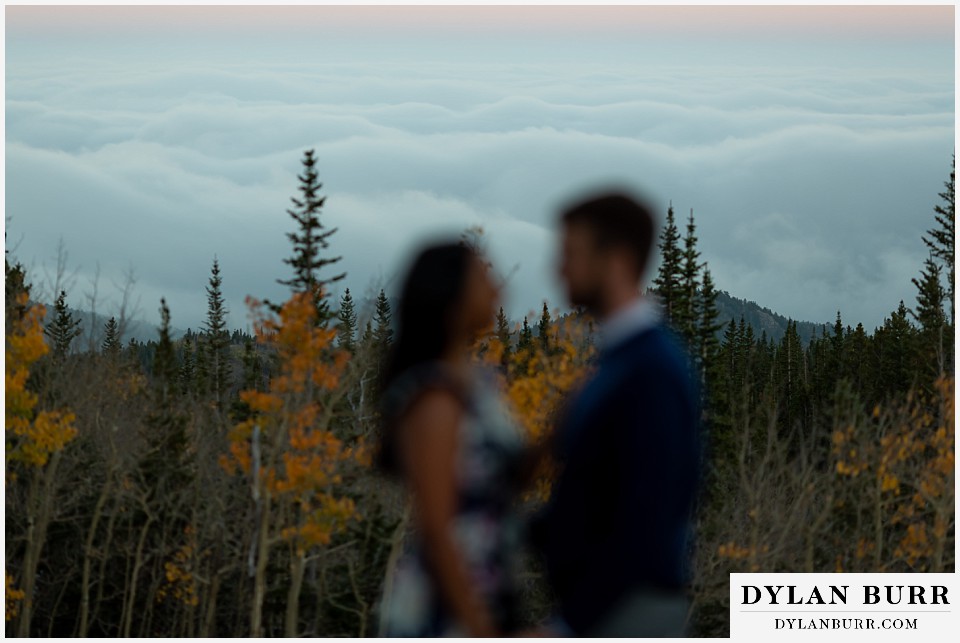 colorado engagement photos in mountains low clouds in background