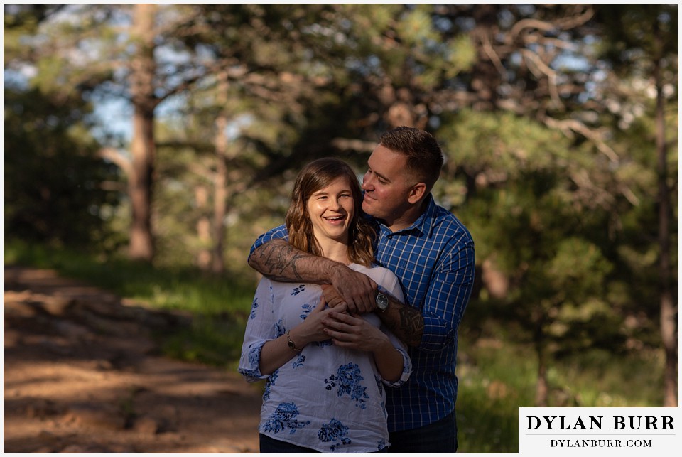 golden colorado mountain enagagement photo session couple snuggling in close in a pocket of sunlight