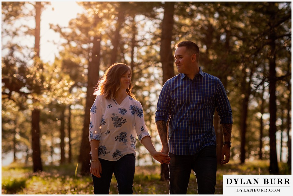 golden colorado mountain enagagement photo session couple he looks lovingly at his fiance
