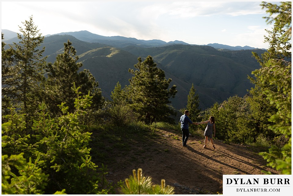 golden colorado mountain enagagement photo session couple dancing in a clearing