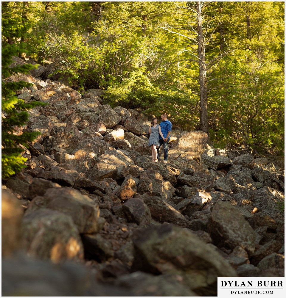 golden colorado mountain enagagement photo session panorama portrait of couple in a rock slide