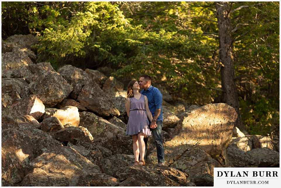 golden colorado mountain enagagement photo session couple going in for kisses