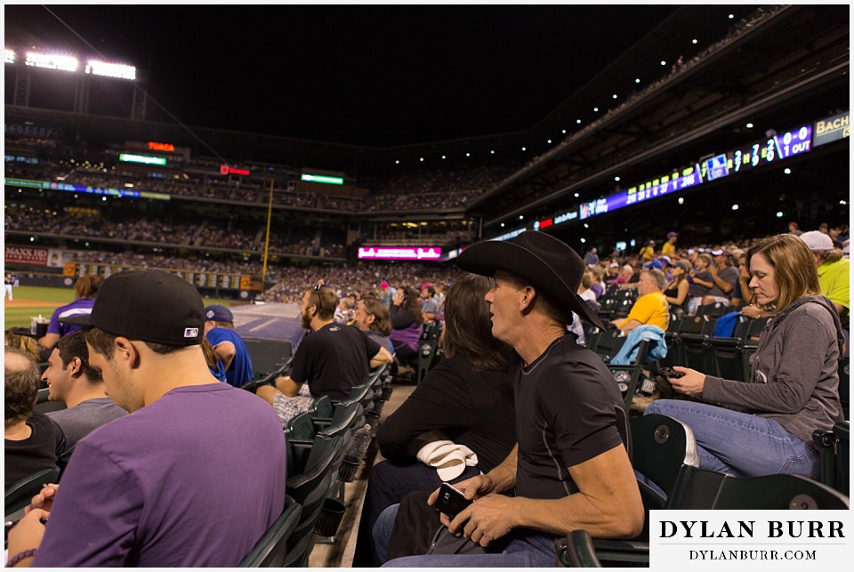 proposal at coors field rockies game couple watching game