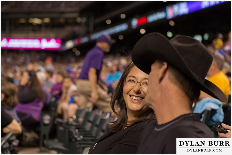 proposal at coors field rockies game couple sitting together shes very happy