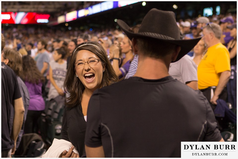proposal at coors field rockies game standing up next to her
