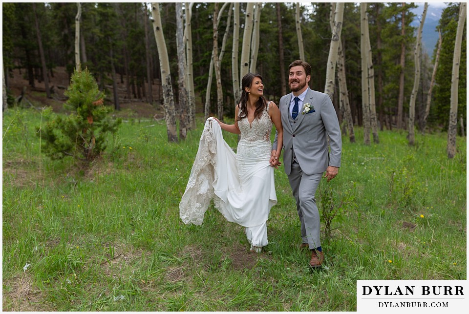 dao house wedding bride and groom walking hand in hand in aspen trees
