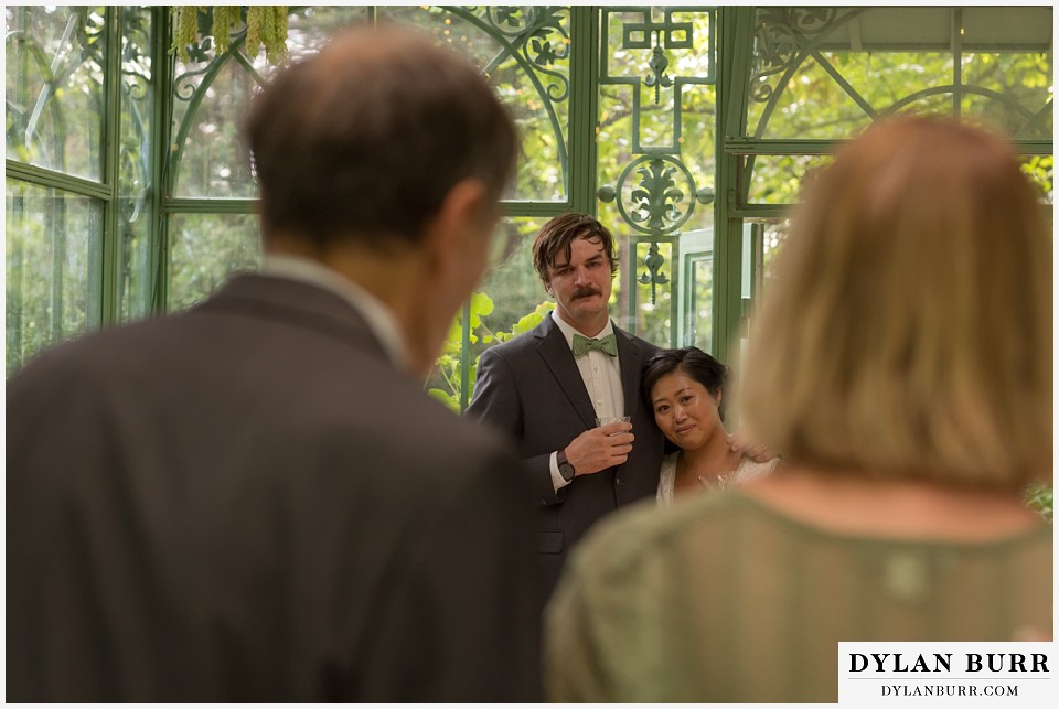 denver botanic gardens wedding colorado woodland mosaic bride groom hearing a very heartfelt toast from parents