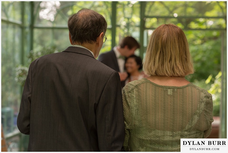 denver botanic gardens wedding colorado woodland mosaic grooms parents look on at bride and groom