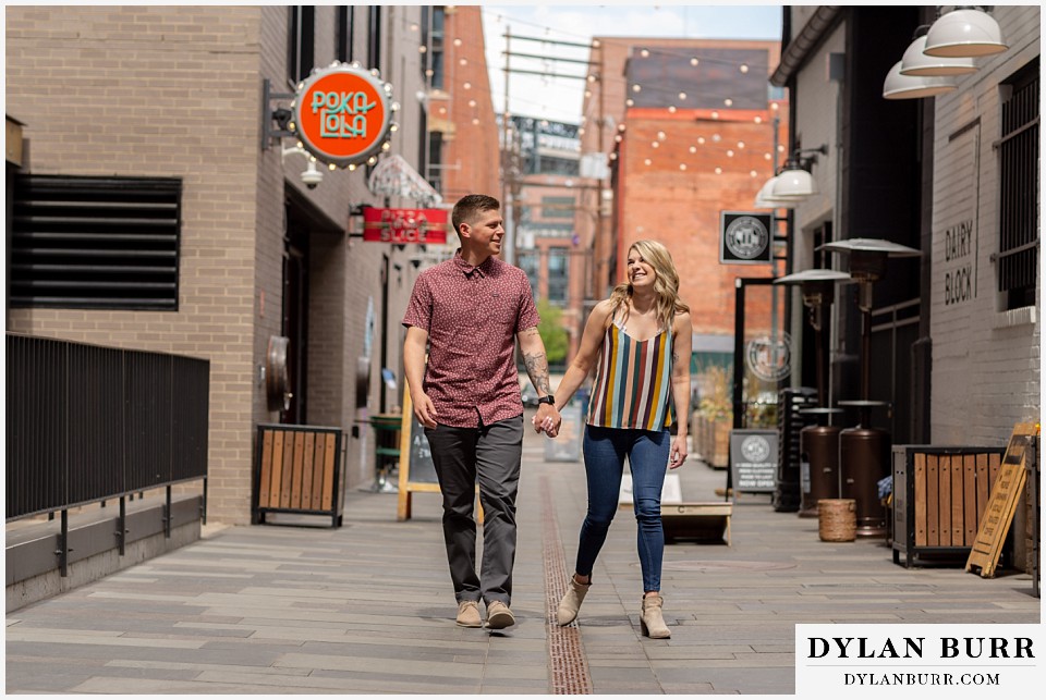 denver engagement photos dairy block downtown denver walking downtown poka lola