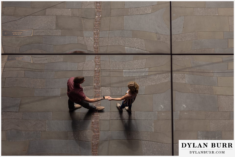 denver engagement photos dairy block downtown denver holding hands in mirror