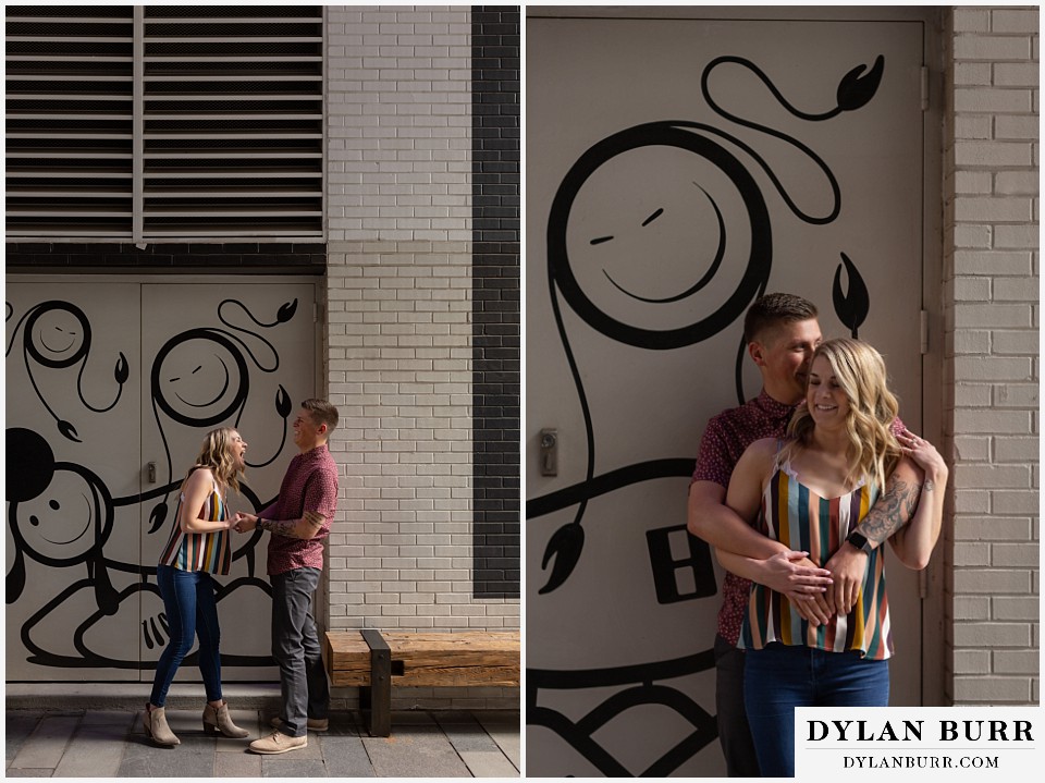 denver engagement photos dairy block downtown denver standing together near street art