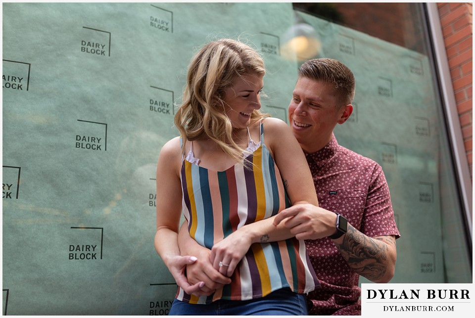 denver engagement photos dairy block downtown denver laughing together