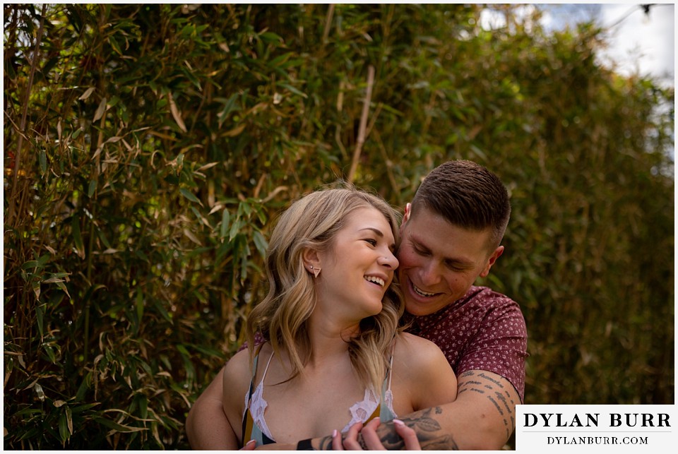 denver engagement photos dairy block downtown denver cuddling next to some bamboo