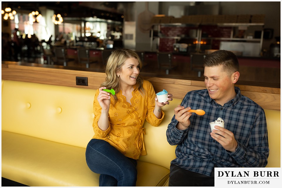 denver engagement photos dairy block downtown denver being goofy while sitting together