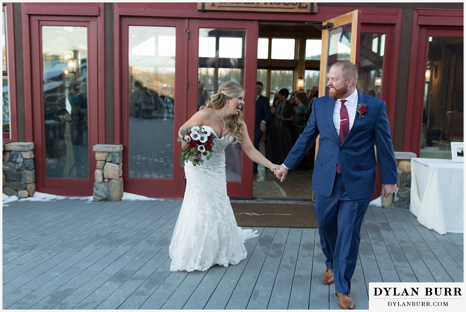 devils thumb ranch wedding in winter ceremony timber house laughing