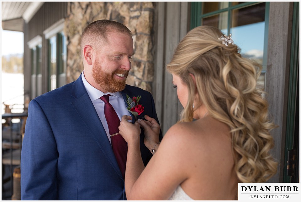 devils thumb ranch wedding in winter grooms boutineer