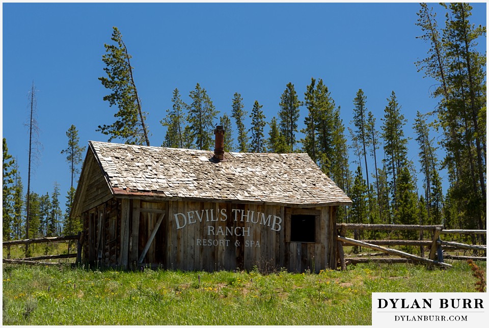 devils thumb ranch wedding old cabin with devils thumb ranch sign on side