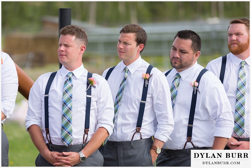devils thumb ranch wedding groomsmen watching ceremony