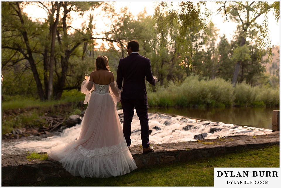 dunafon castle wedding couple with drinks at sunset by the river