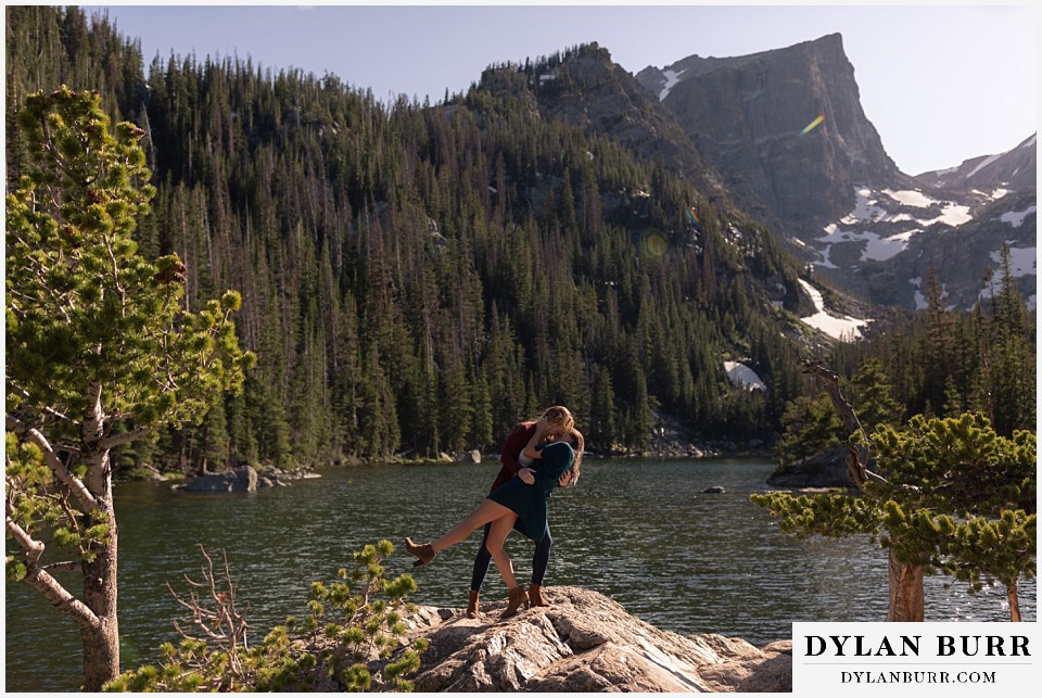estes park engagement photos dancing and dipping fiance at high alpine lake