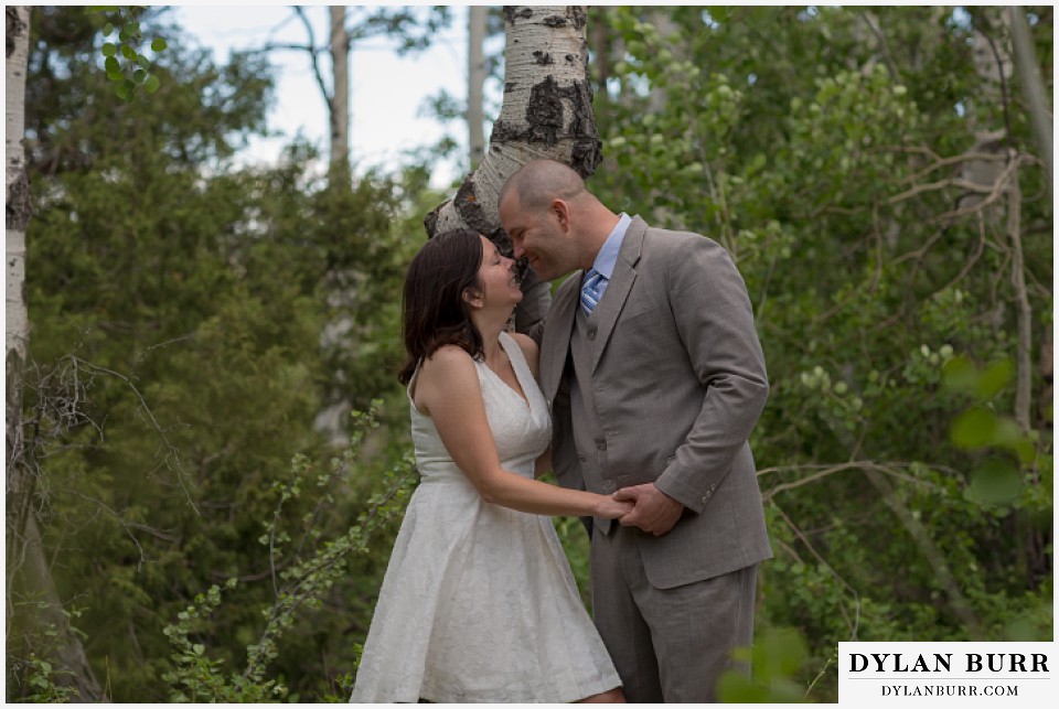 rocky mountain estes park engagement session kissing near aspen trees