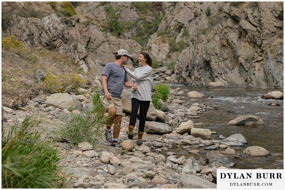 estes park marriage proposal couple playing together at the rive