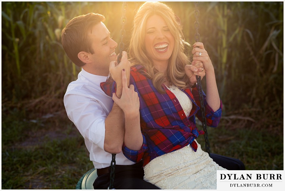 fall anniversary photos bride and groom riding on tire swing