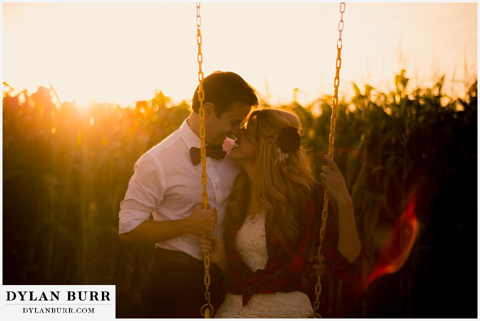 fall anniversary photos couple on swing set at sunset