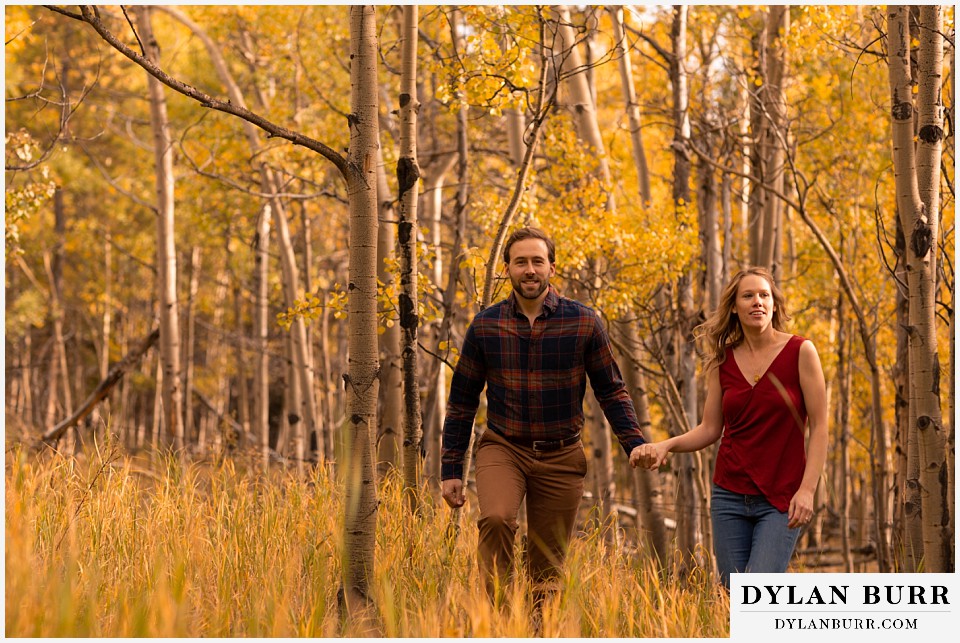 fall engagement photos in colorado couple in sunlight aspen grove