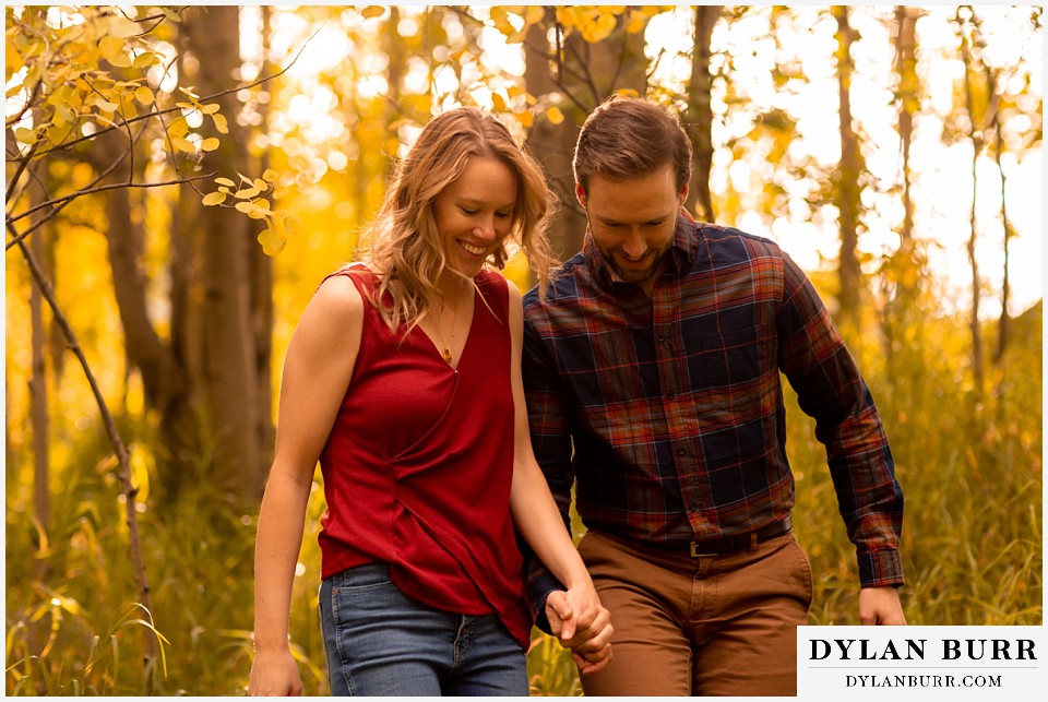 fall engagement photos in colorado happy couple in mountains together